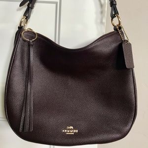 Coach shoulder bag with gold tone accents.